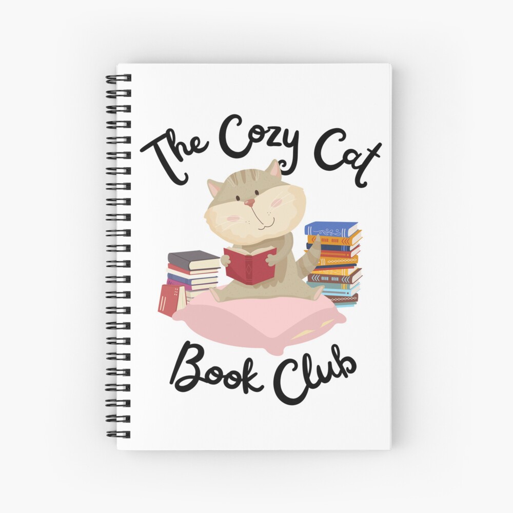 Spiral notebook and on the cover is a cute cat sitting on a cushion and holding a book, with stacks of books behind. "The Cozy Cat Book Club" surrounds the image.