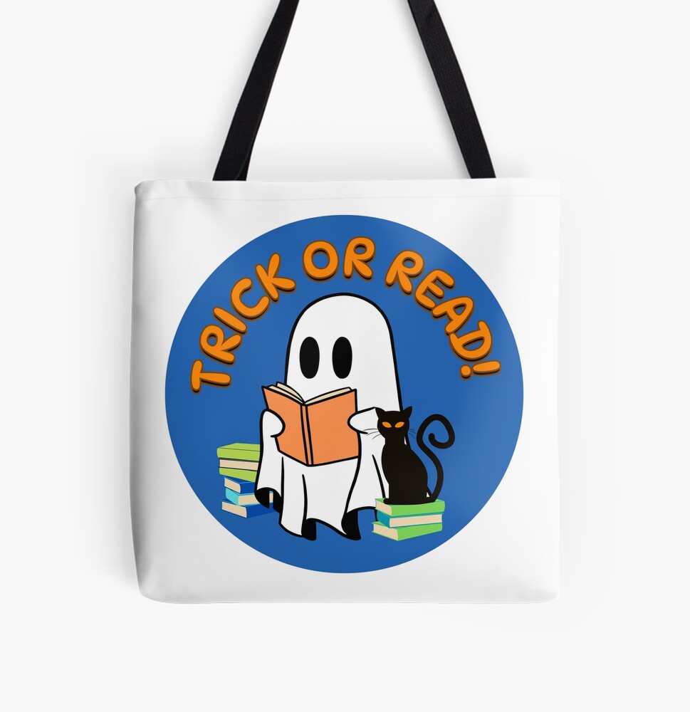 White tote bag with black handles. The design on the bag is a cute ghost reading a book, with stacks of books beside it and a black cat sitting on top one of the book stacks. They're in a blue circle with the words "Trick or read!" in orange above the ghost, because reading is the best treat.